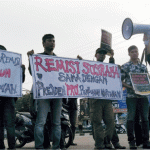 Puluhan jurnalis dari berbagai media di Kota Kendari menggelar aksi demonstrasi di Jalan Ahmad Yani, Jumat (25/1/2019) untuk mendesak Presiden Joko Widodo mencabut remisi Susrama. (Foto : AJI Kendari)